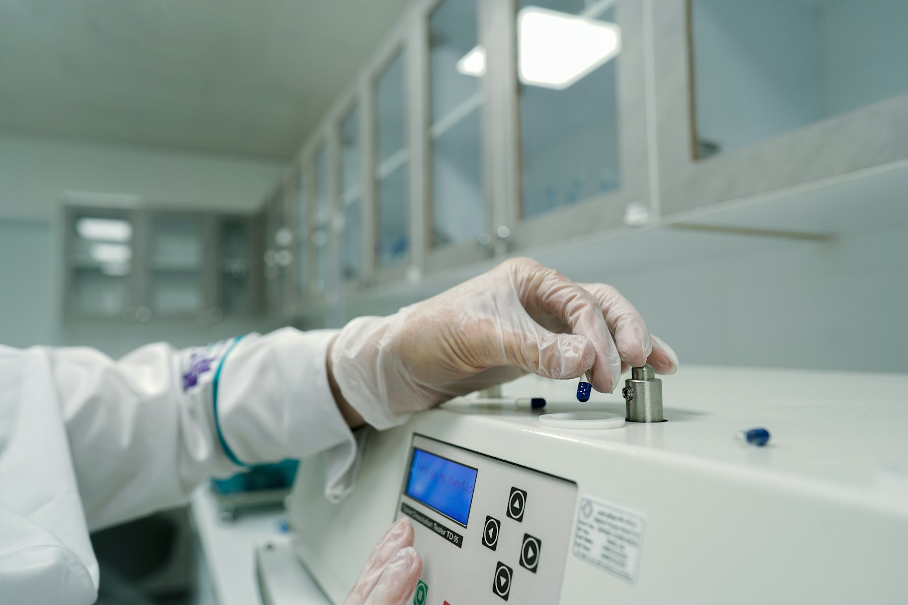 Analyst operating a laboratory instrument in a quality-control lab